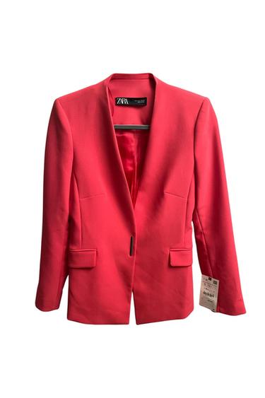 Front view of a red blazer with front flap pockets and a visible tag.