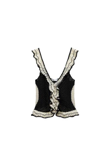 Black crochet top with beige ruffles on straps, V-neck, centre, and hem. ZARA label visible inside. White background.