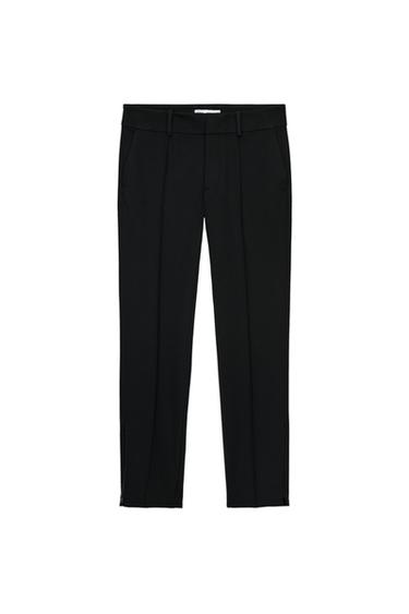 Front view of black trousers with side pockets, belt loops, and a concealed fastening.