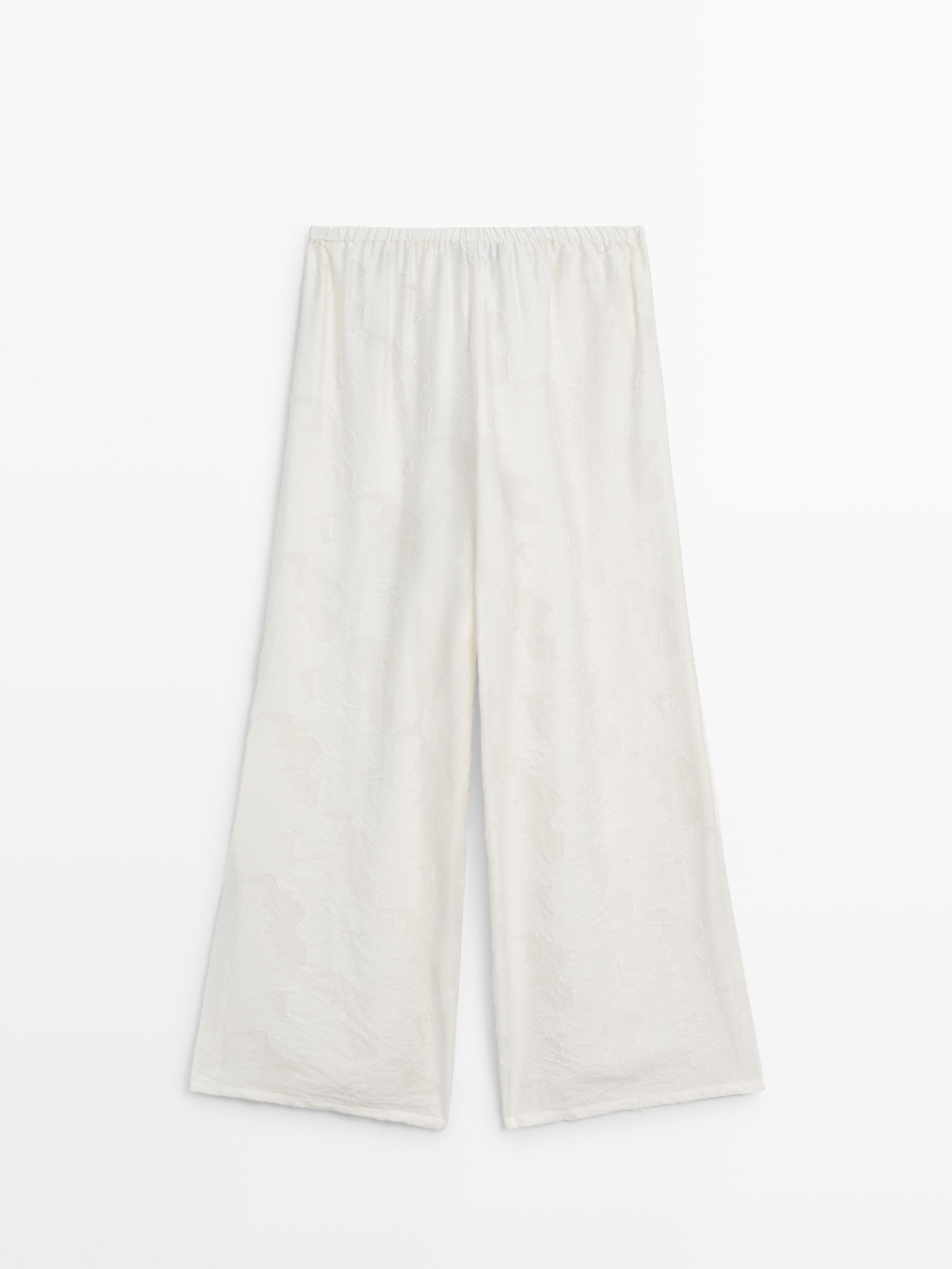 Flowing stretch trousers with fabric detail