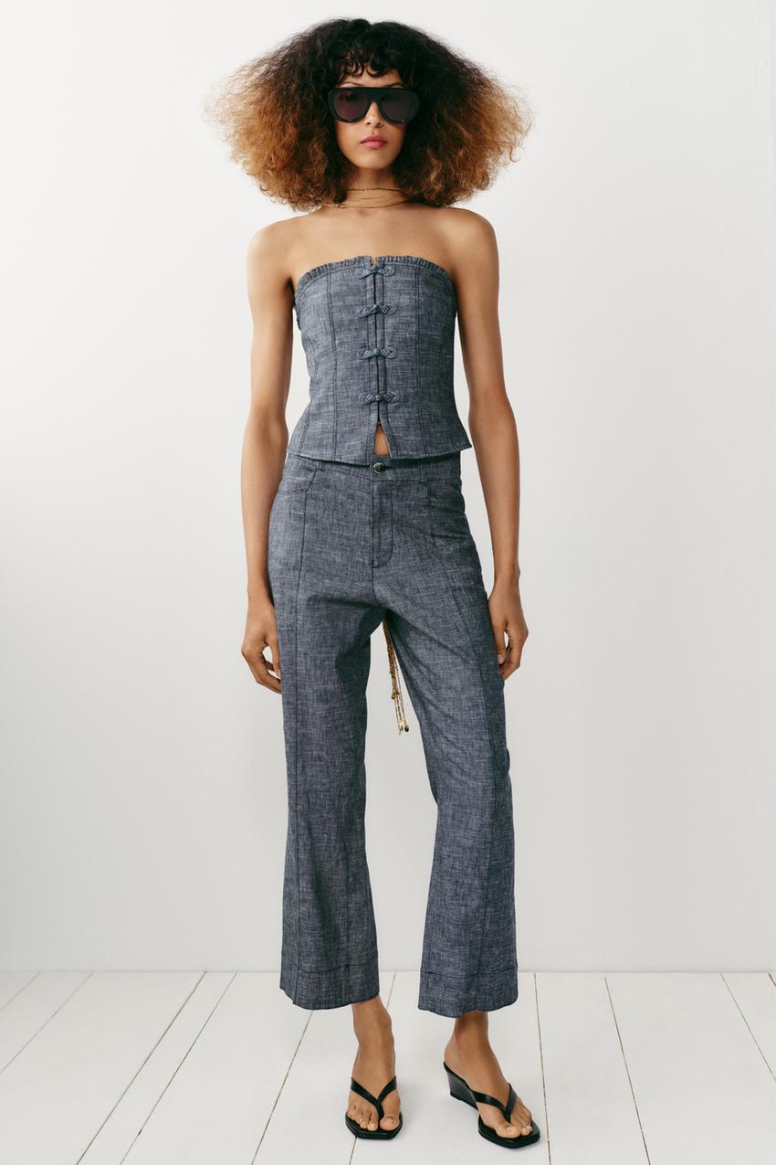 Gray off-the-shoulder top and matching pants set, featuring a straight neckline and frog closures on the top, and front seams and front pockets on the pants.