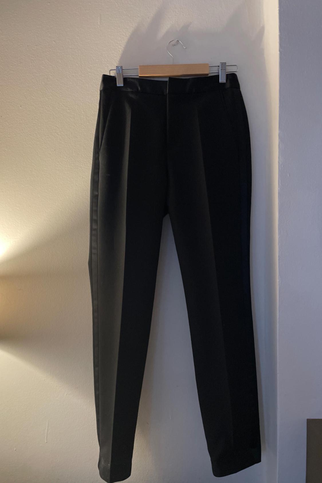 Front view of black trousers with side pockets.