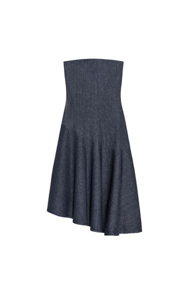 Front view of a dark indigo dress, strapless neckline, fitted cut, asymmetric hem and midi length.