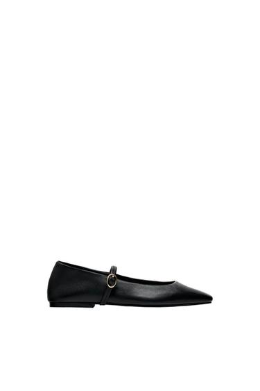 Black pointy-toed ballet flat with strap and gold buckle on white background.
