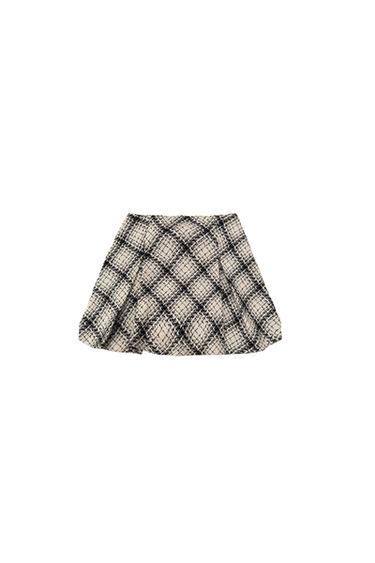 Front view of a short black and white checked skirt.