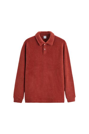 Terracotta-coloured fleece jersey with a polo collar and buttons. Visible label on the collar with the text "Zara". White background.