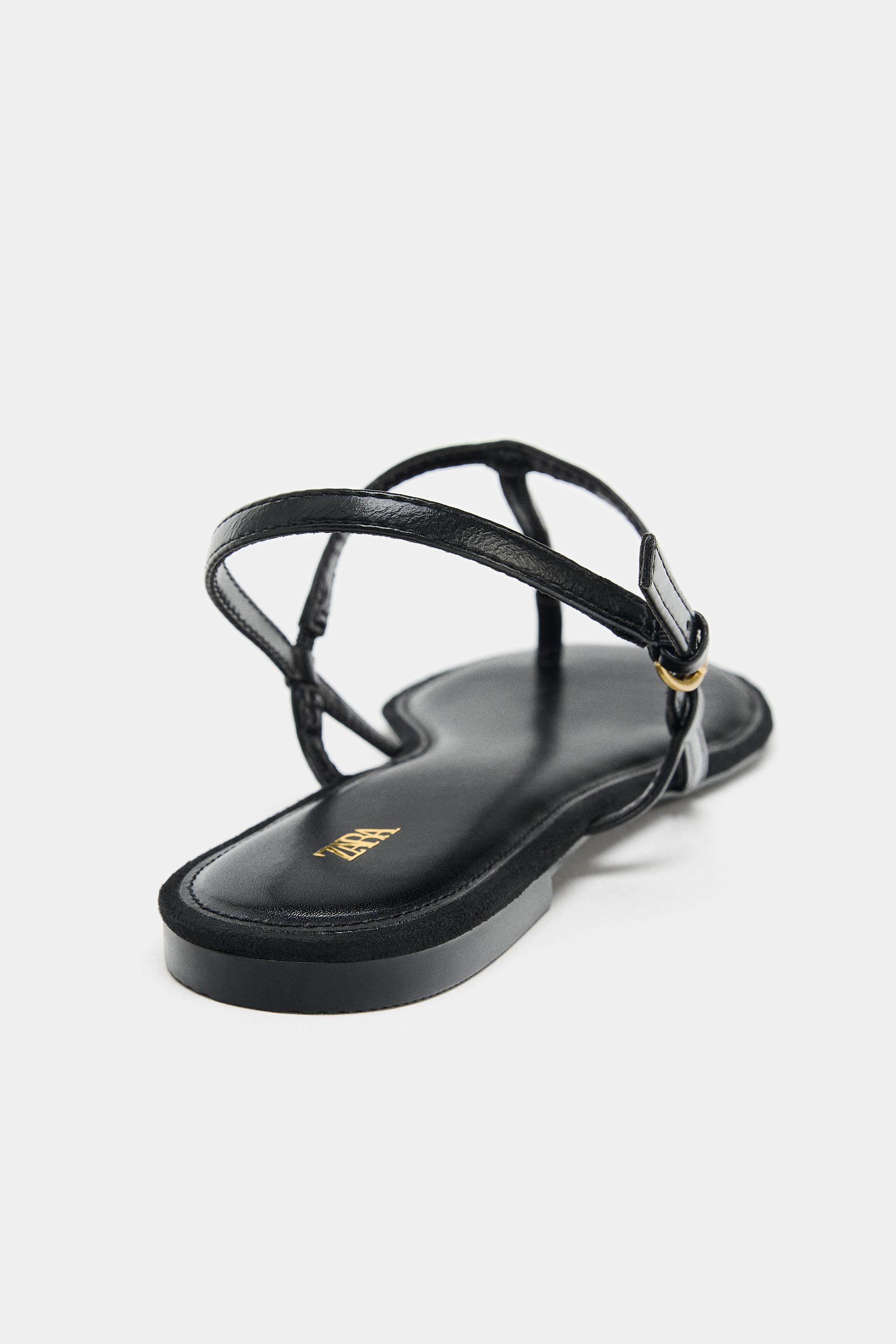 FLAT SANDALS WITH METALLIC APPLIQUE