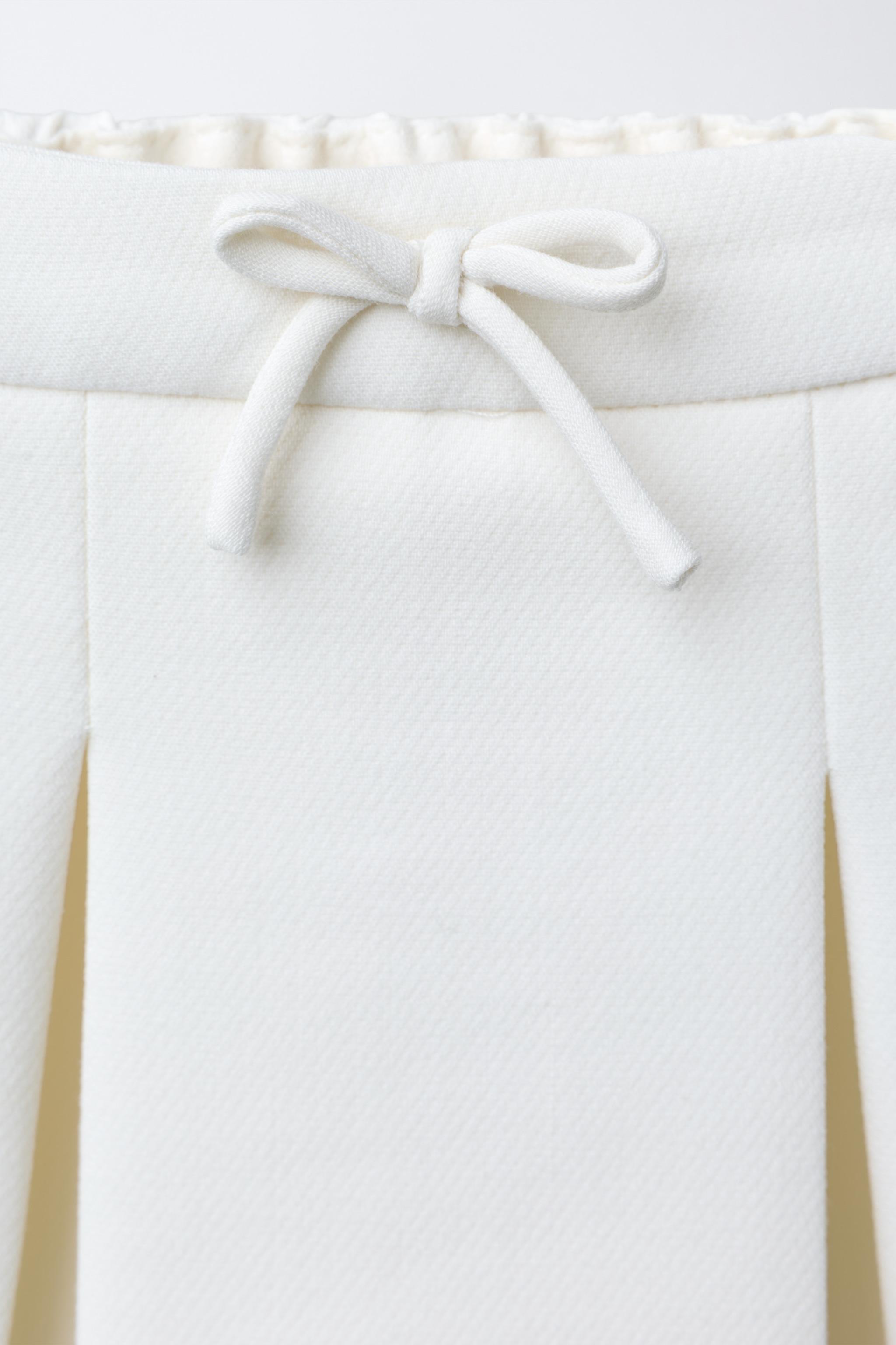 JUPE À PLIS PLATS AVEC TULLE AU BAS