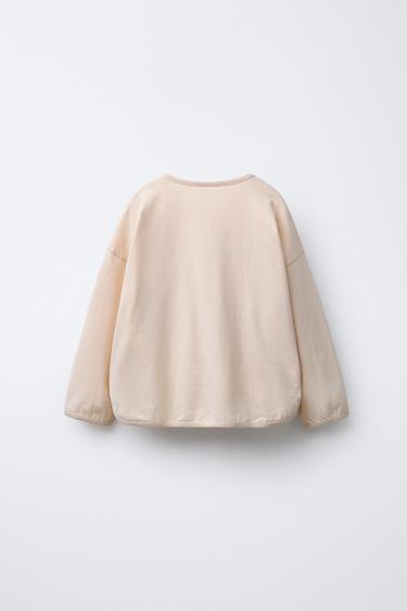 T-SHIRT AVEC INSCRIPTION ET PIÈCES - Rose clair de Zara - Image 1