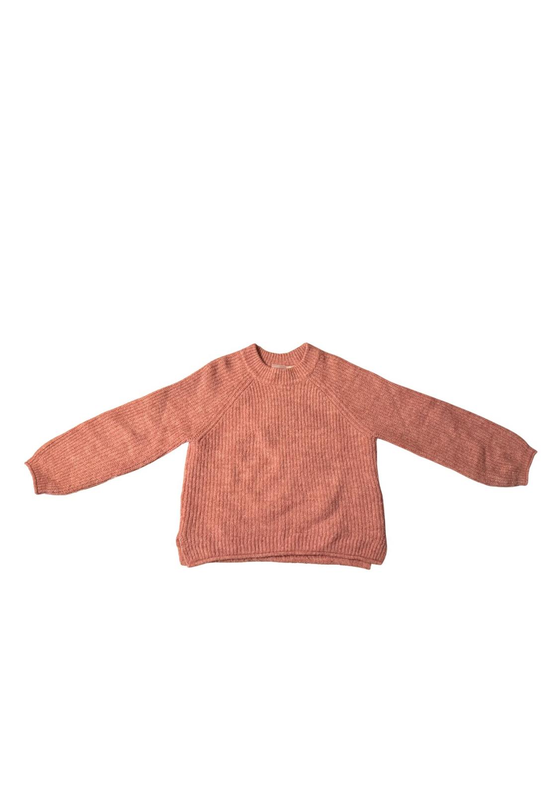 Pink knitted jumper on a white background, with long sleeves and a round neck.