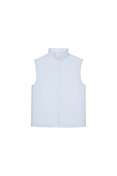 White sleeveless blouse with a high neck, presented on a white background.