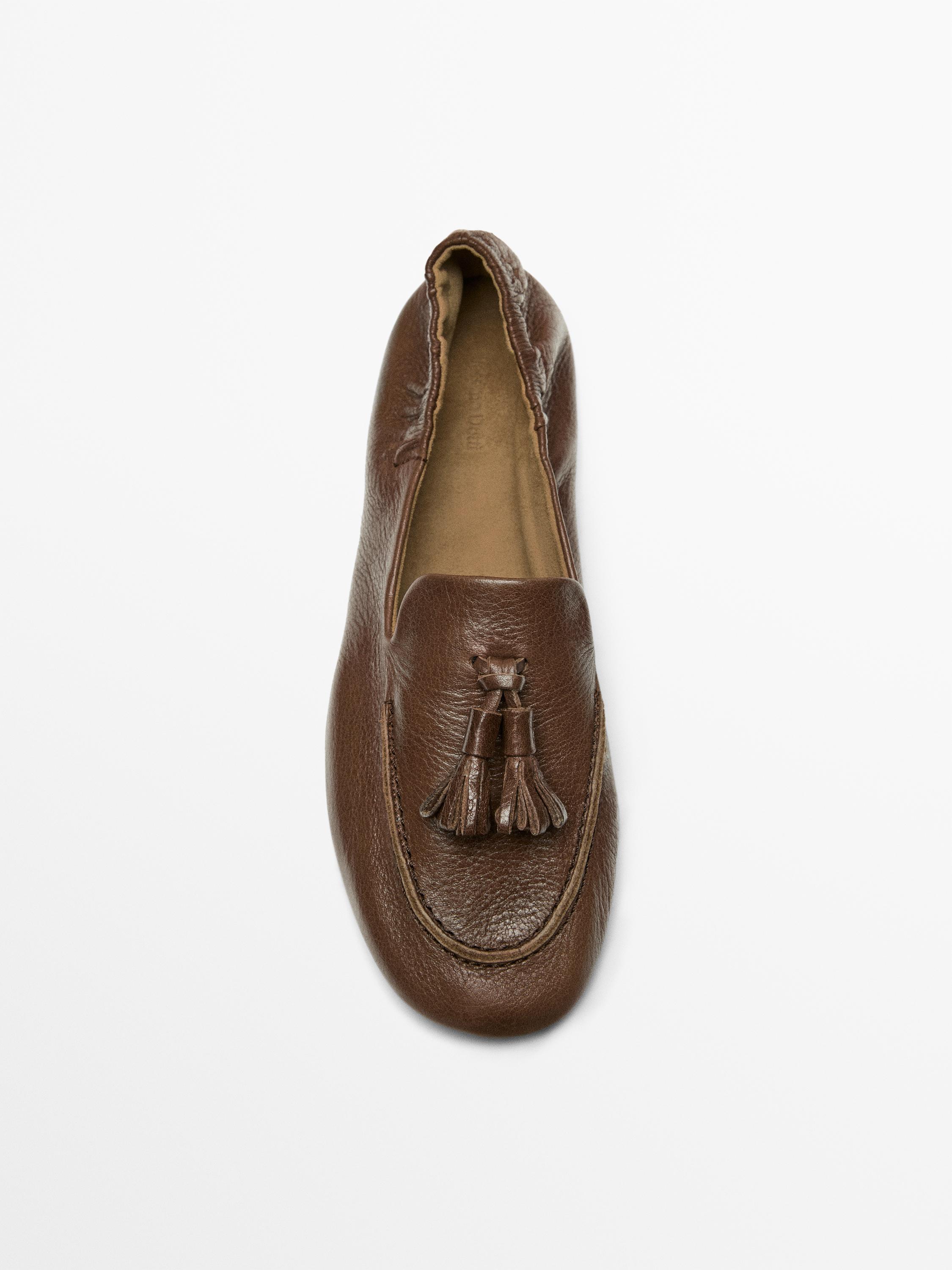 Mocassin en cuir à pompons