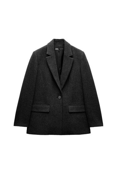 Front view of dark grey jacket with lapel and front pockets.