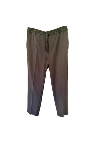 Dark straight-leg trousers with an elasticated waistband, adjustable drawstring and front pleat, photographed against a white background.