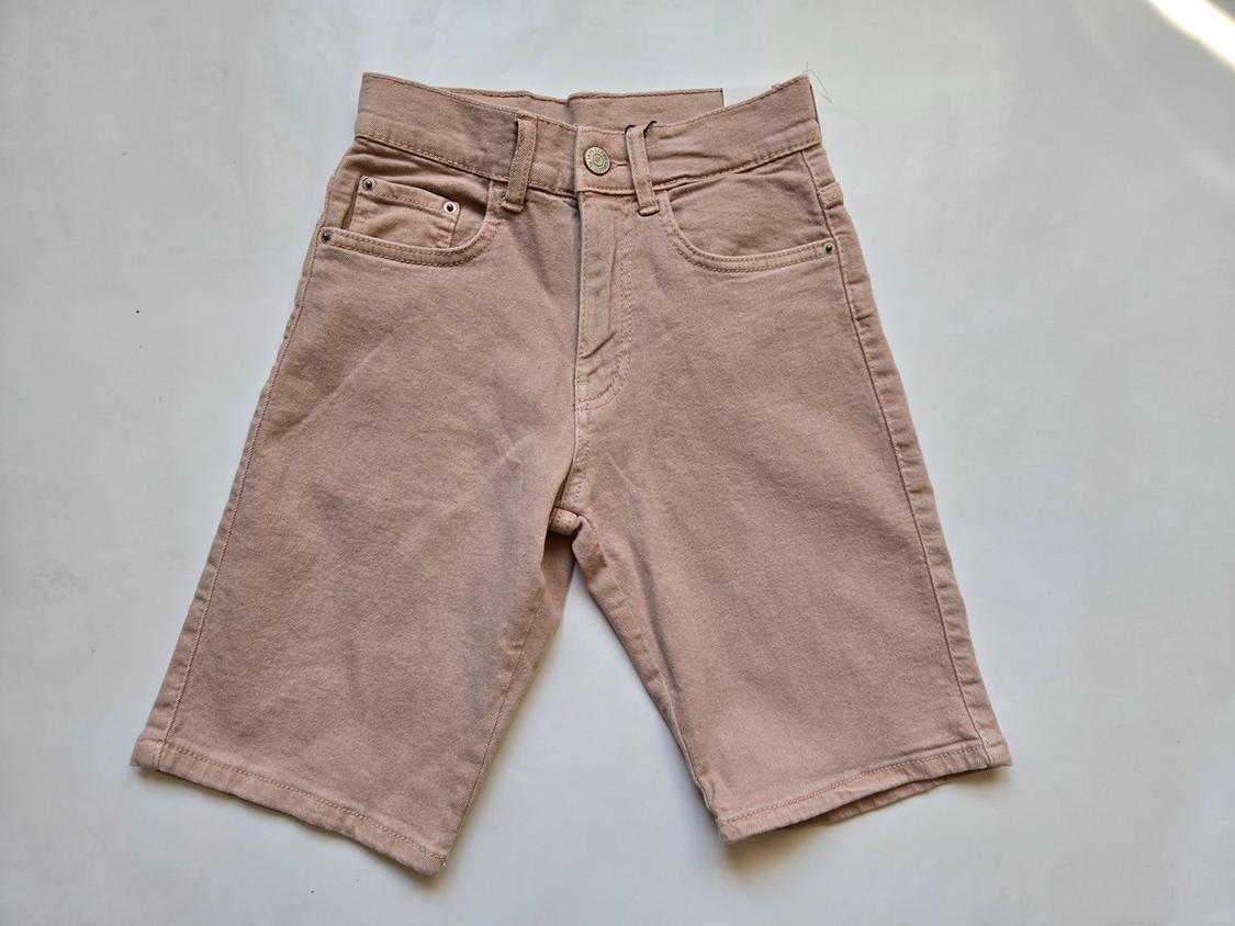 Front view of pink shorts with front pockets and belt loops.