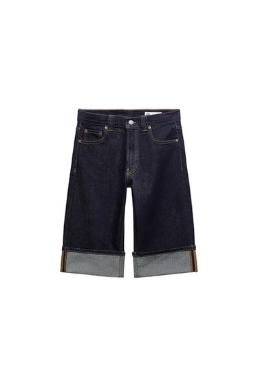 Dark blue denim shorts with five pockets, contrast stitching, and a rolled hem on a white background.
