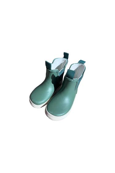 Olive green water boots with a white sole and light inner lining, on a white background.