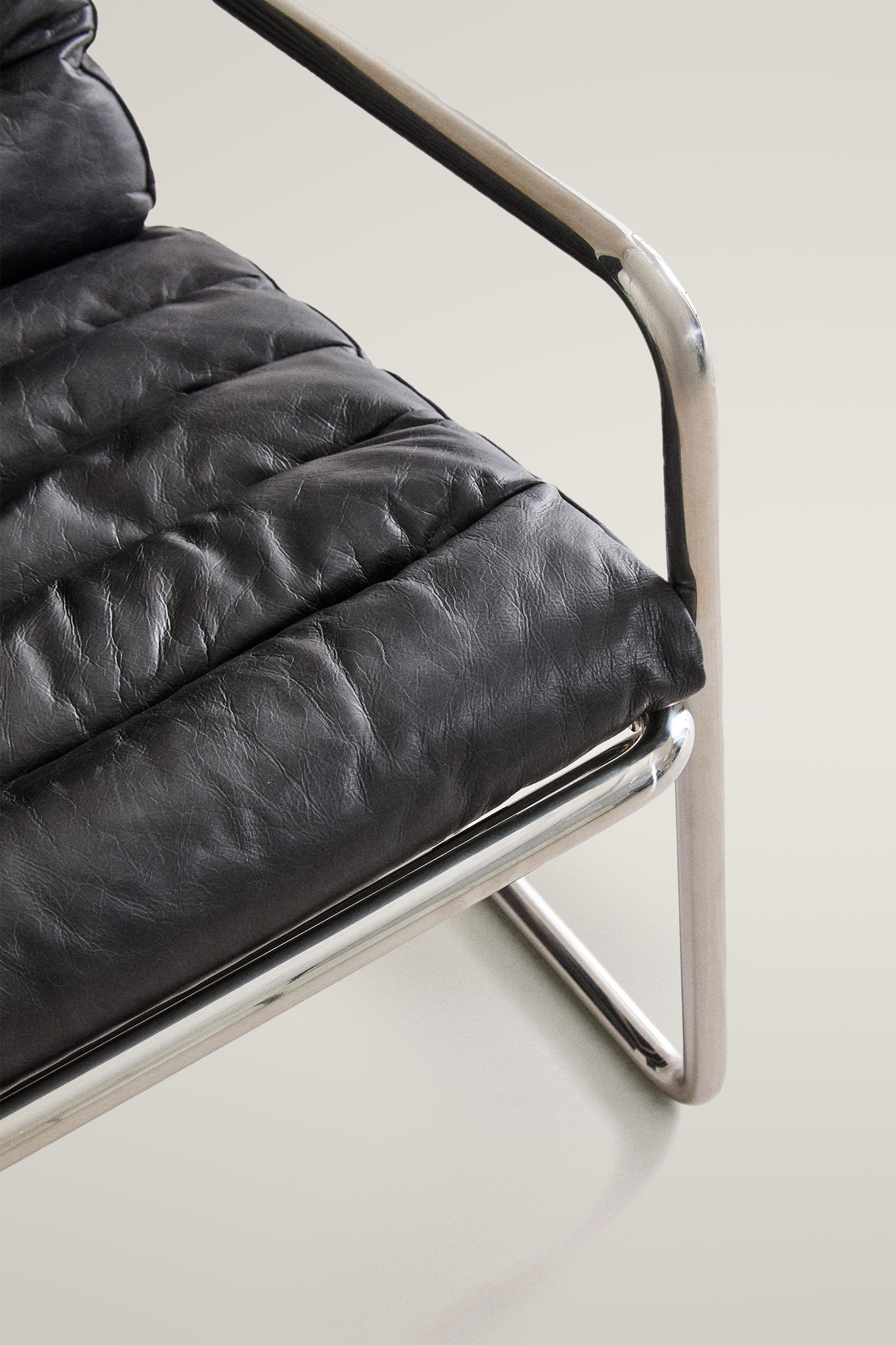 LEATHER AND STAINLESS STEEL ACCENT CHAIR