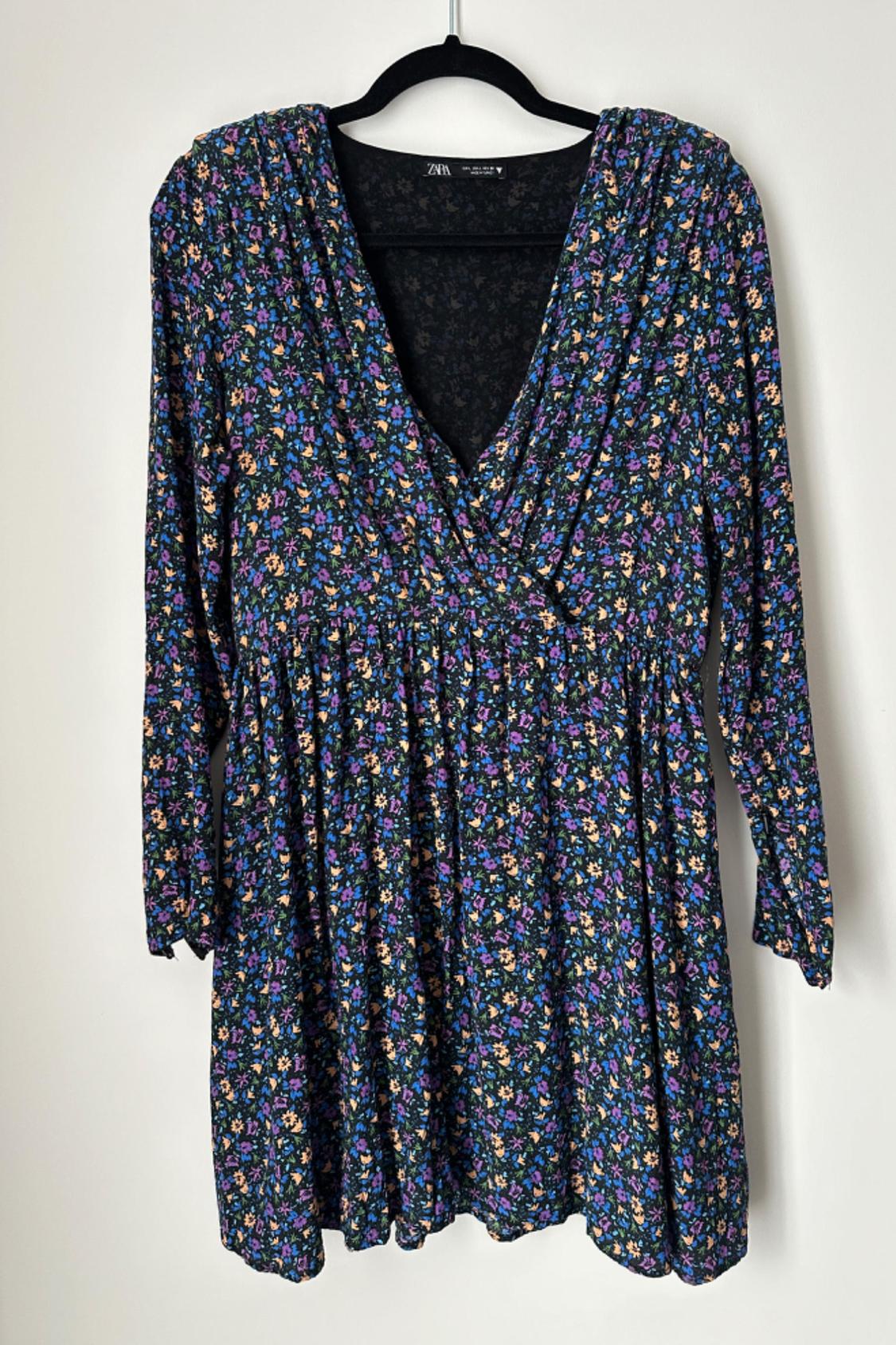 Front view of a long-sleeved floral dress with a V-neck and cinched waist.