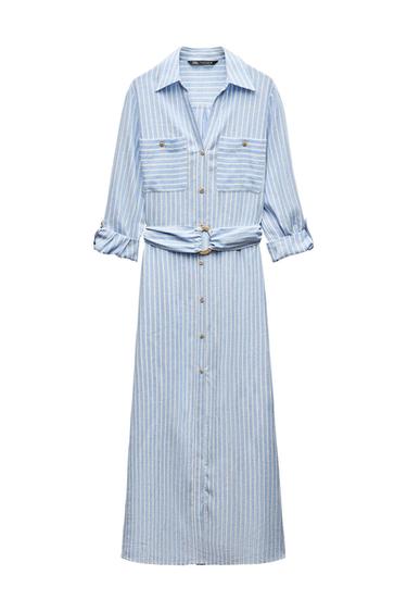 Blue shirt dress with white stripes, front pockets, matching belt, and gold buttons. Long sleeves rolled up.