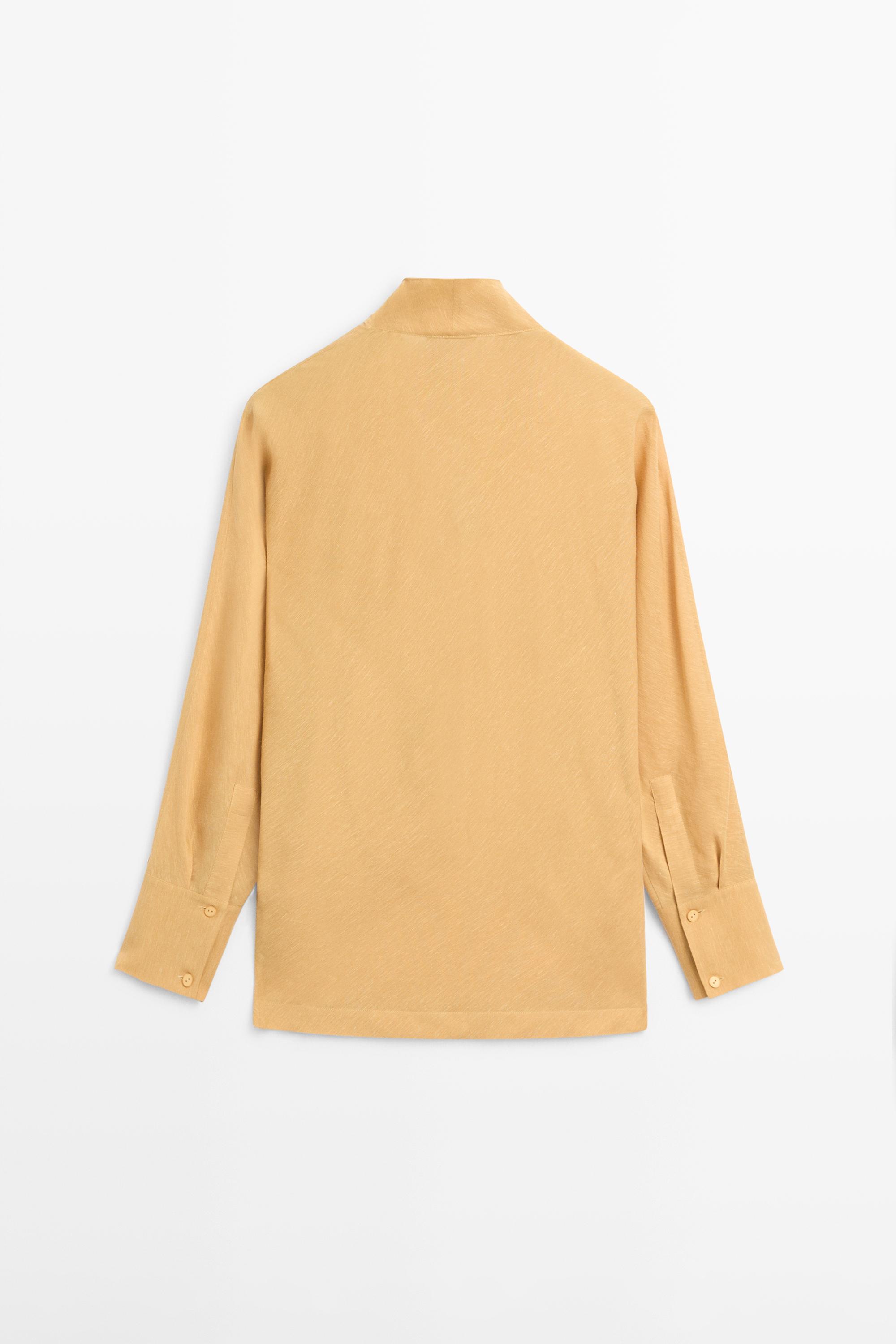 Blouse fluide à décolleté drapé