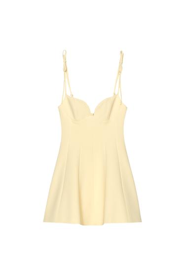 Front view of a short yellow dress with spaghetti straps and a sweetheart neckline