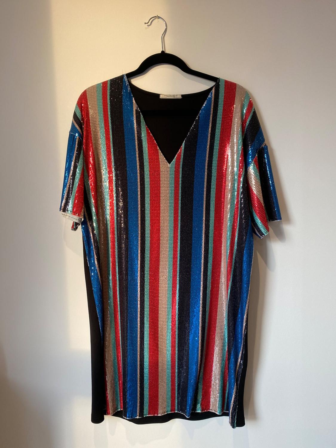 Front view of multicoloured vertically striped dress with V-neck and short sleeves.