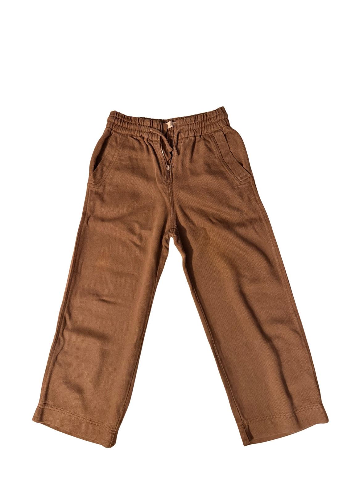 Straight-cut brown trousers with an elasticated waist and adjustable drawstring, presented on a white background.