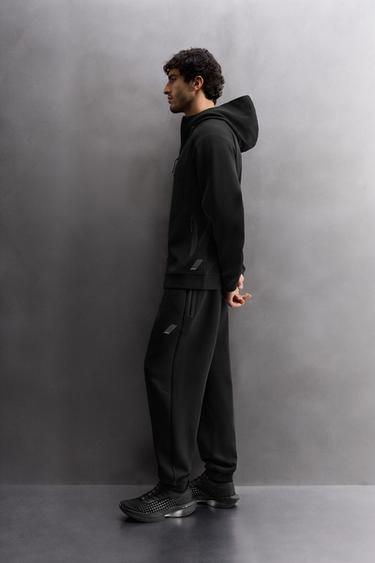 TECHNICAL TROUSERS WITH ZIP - Black by Zara