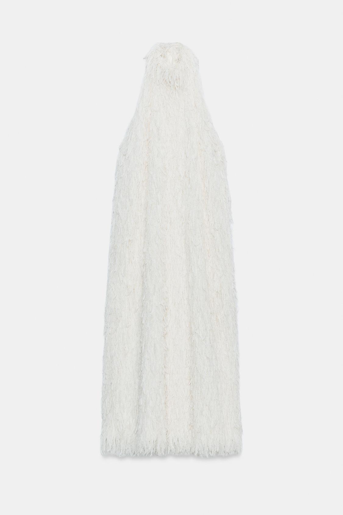 Front view of a sleeveless white dress, halter neck, fluffy texture, open back with lacing, straight hem.