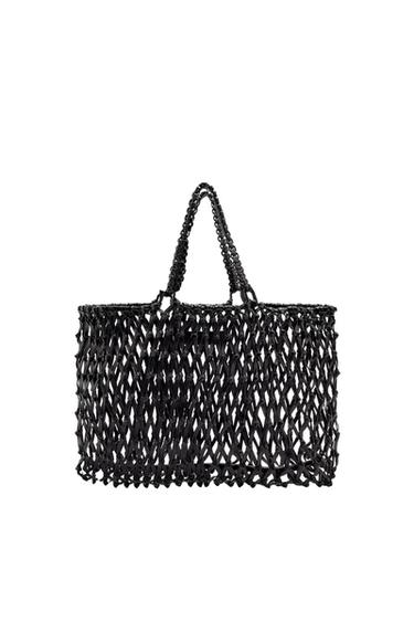 Black handbag with an open mesh design and braided handles, on a white background.