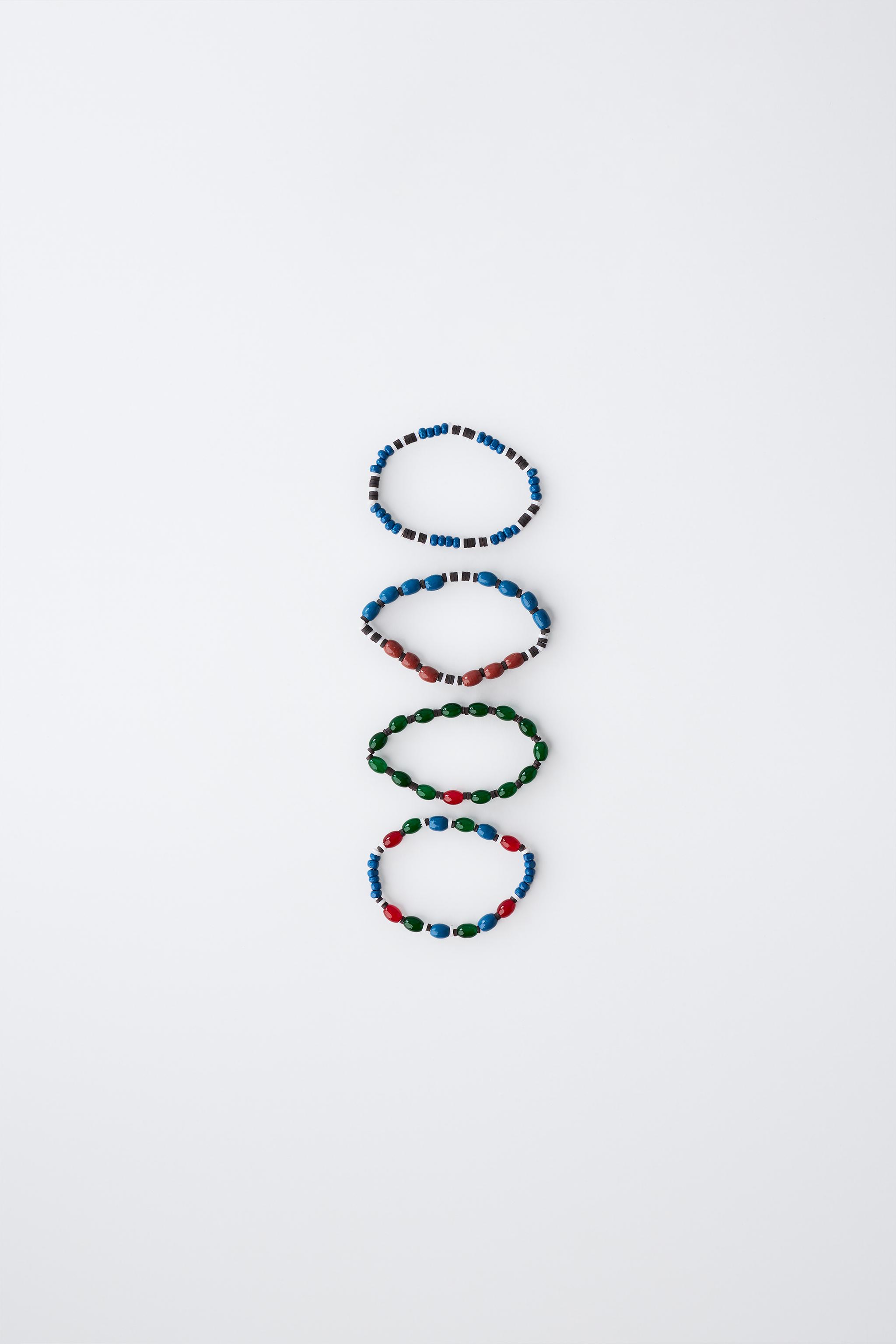 LOT DE QUATRE BRACELETS FANTAISIE