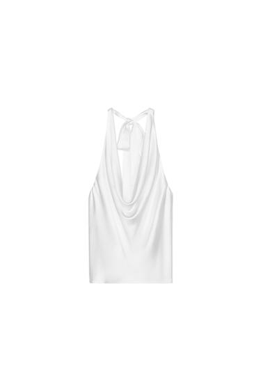 Rear view of a white blouse with a draped neckline and tie-up straps.