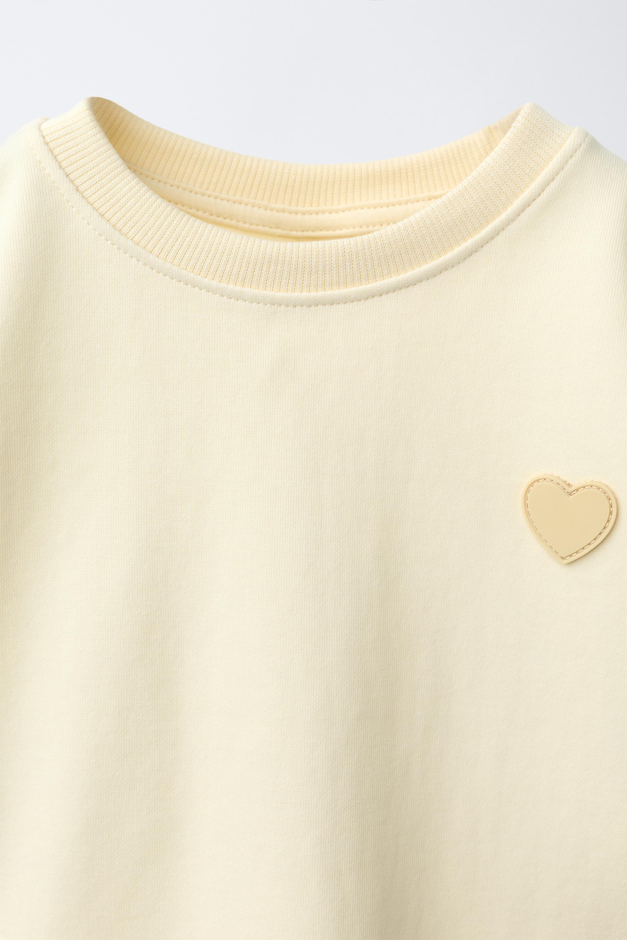INTERLOCK BOW AND HEART SWEATSHIRT