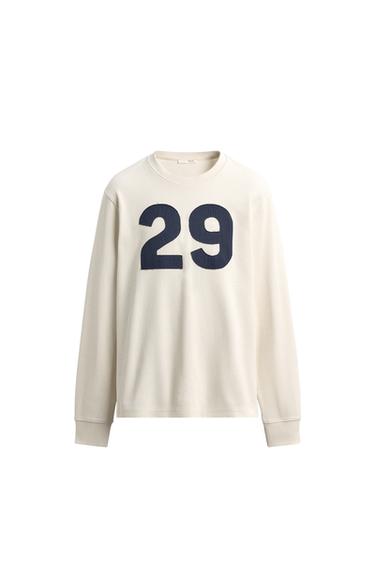 Front view of a raw long-sleeve crewneck t-shirt with the number "29" on the chest. Waffle knit.
