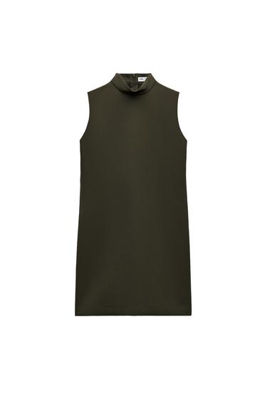 Front view of sleeveless dark green dress with high neck