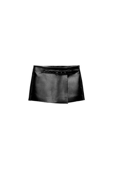 Front view of a short black skirt with a decorative belt and a front flap.