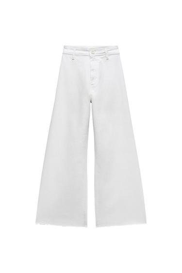 White wide-leg, high-waisted trousers with a front button fastening, photographed against a white background.