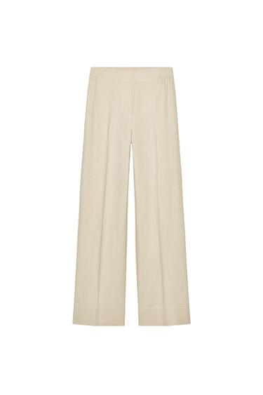 Front view of beige wide-leg trousers with elasticated waistband.