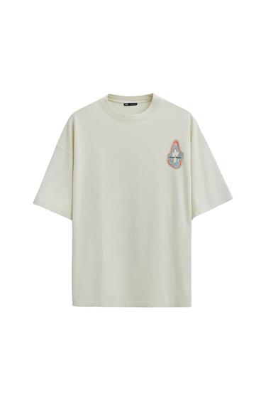 White short-sleeved t-shirt with small chest print that says "Choose your frequency". White background.