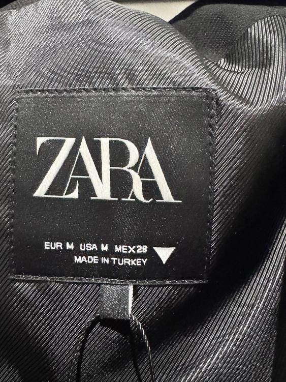 Zara black label on shiny fabric, with text: "EUR M USA M MEX 28B MADE IN TURKEY".