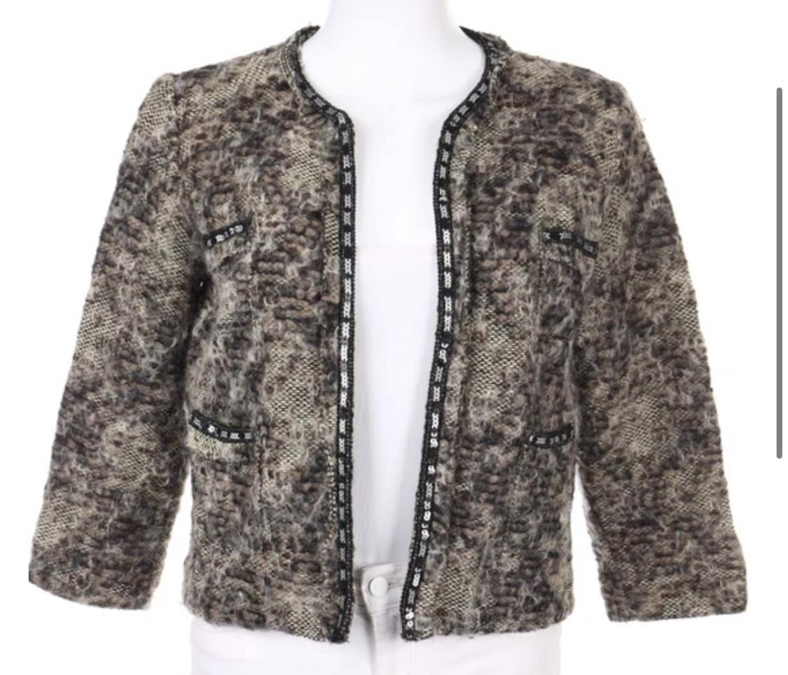 Textured brown and grey jacket, open-front, collarless design with three-quarter sleeves and black trim on the edges and pockets, on a white background.