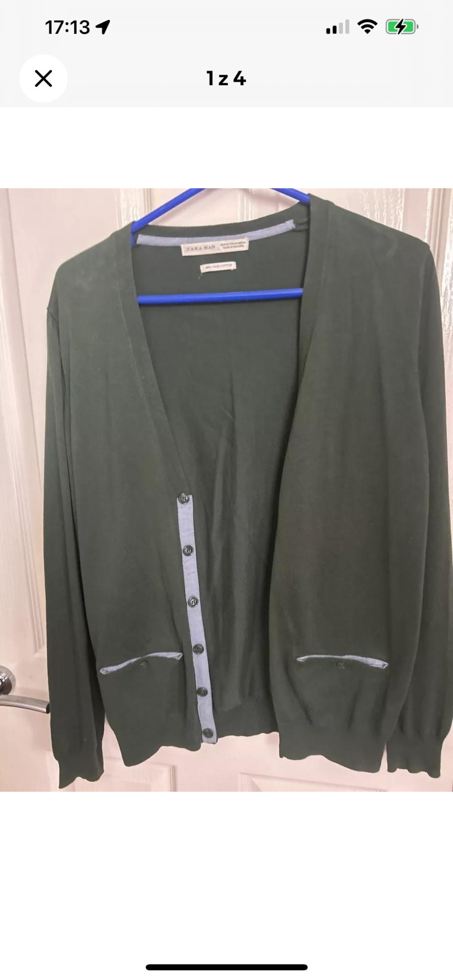 Front view of a green cardigan with dark buttons and front pockets.