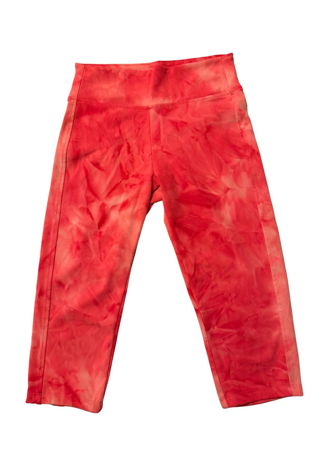 Red tie-dye effect leggings, high-waisted and capri cut, on a white background.