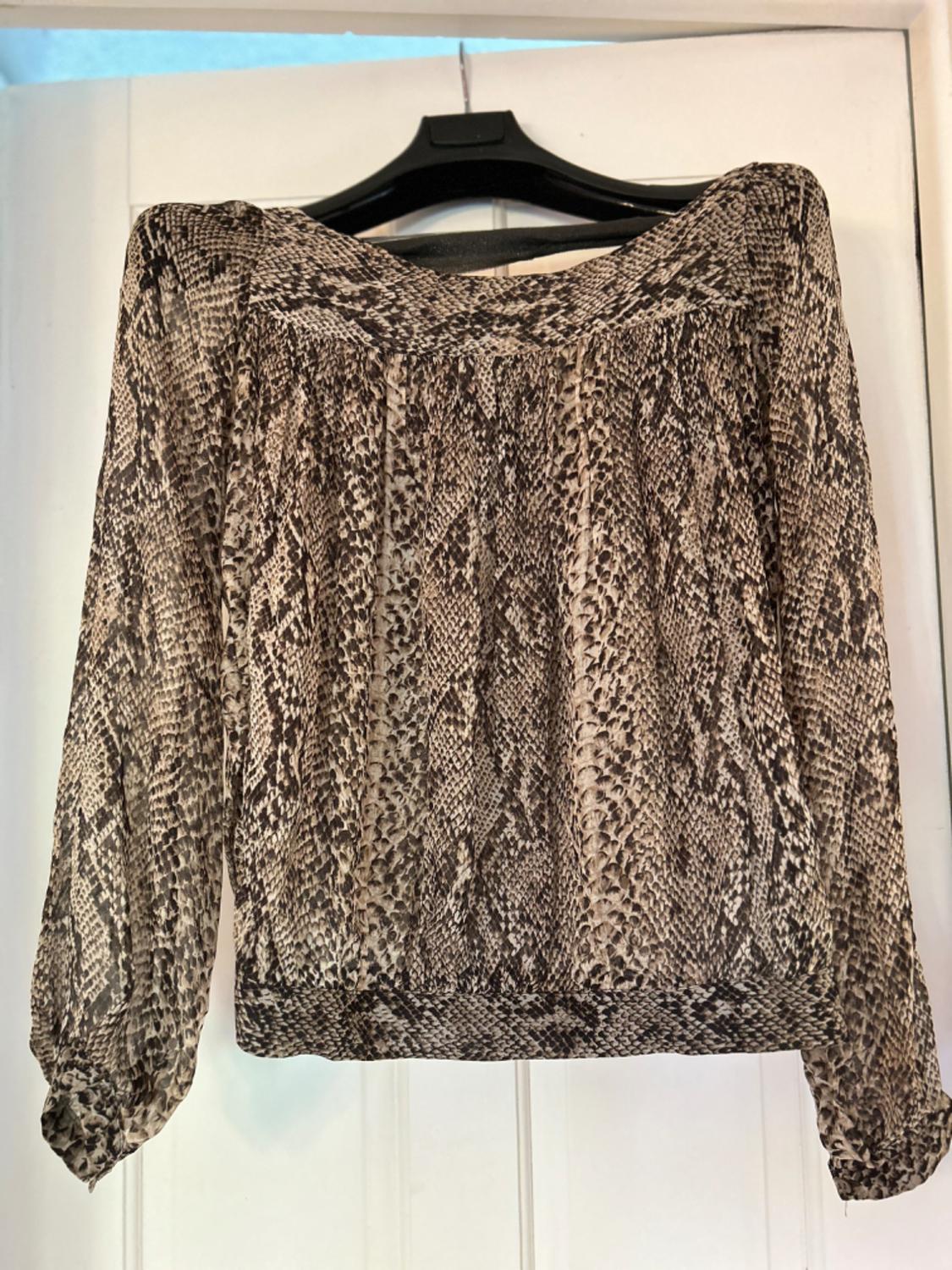 Front view of snake print blouse with long sleeves.