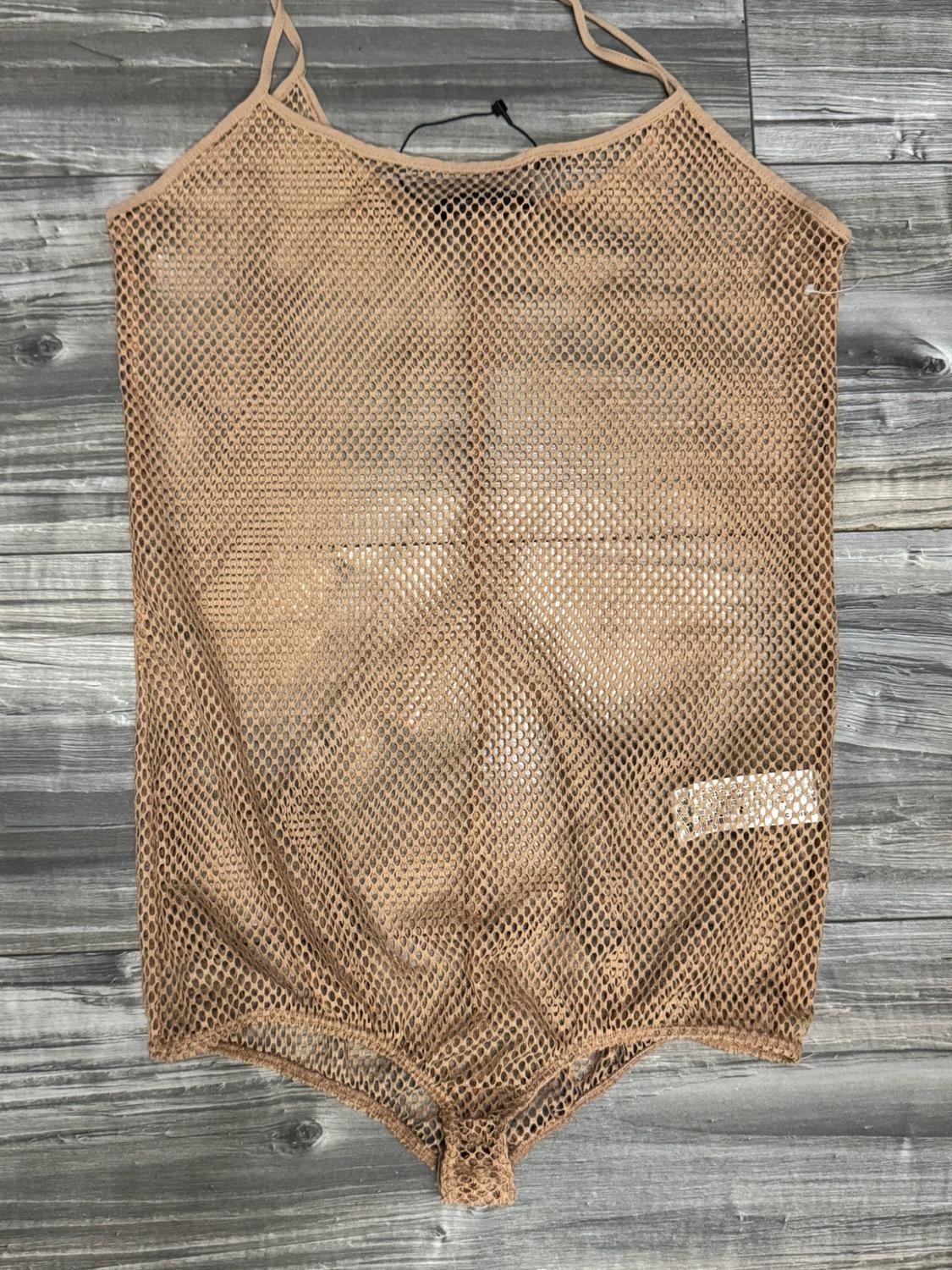 Beige mesh bodysuit with thin straps, presented on a grey wooden surface.