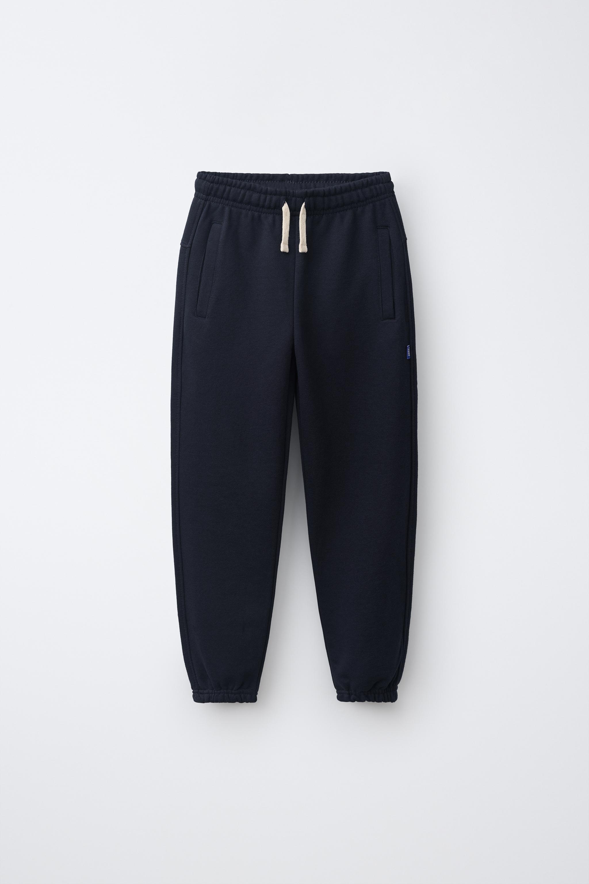 PANTALON DE JOGGING EN MOLLETON UNI AVEC ÉTIQUETTE