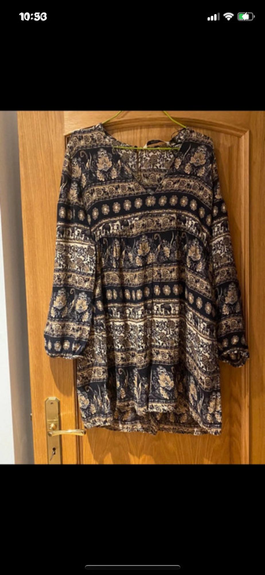 Front view of a blouse with a dark floral print, long sleeves and a relaxed fit.