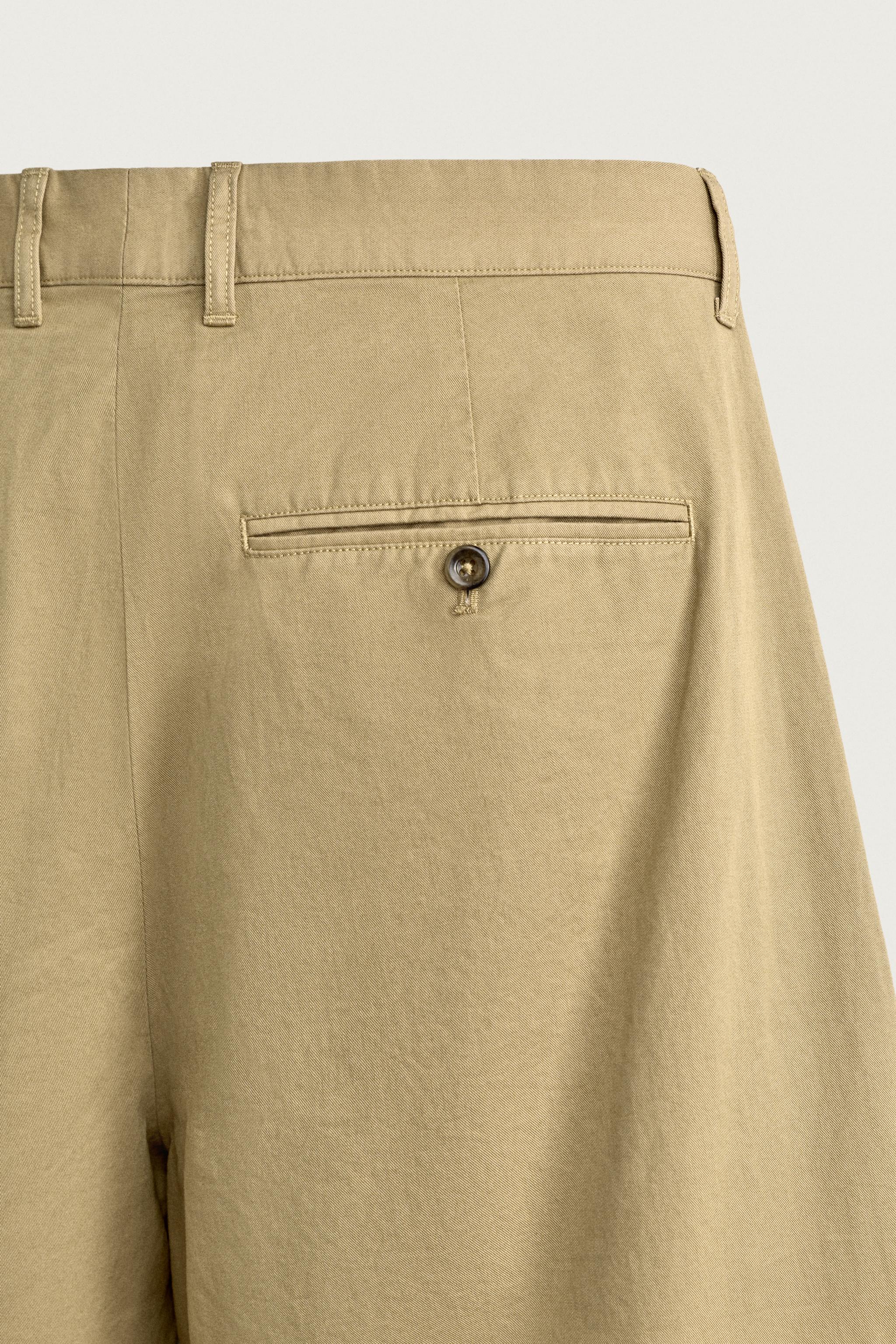 PLEATED CHINO PANTS