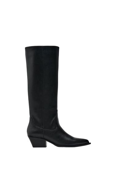 Black high leather boot with a low heel and pointed toe, on a white background.